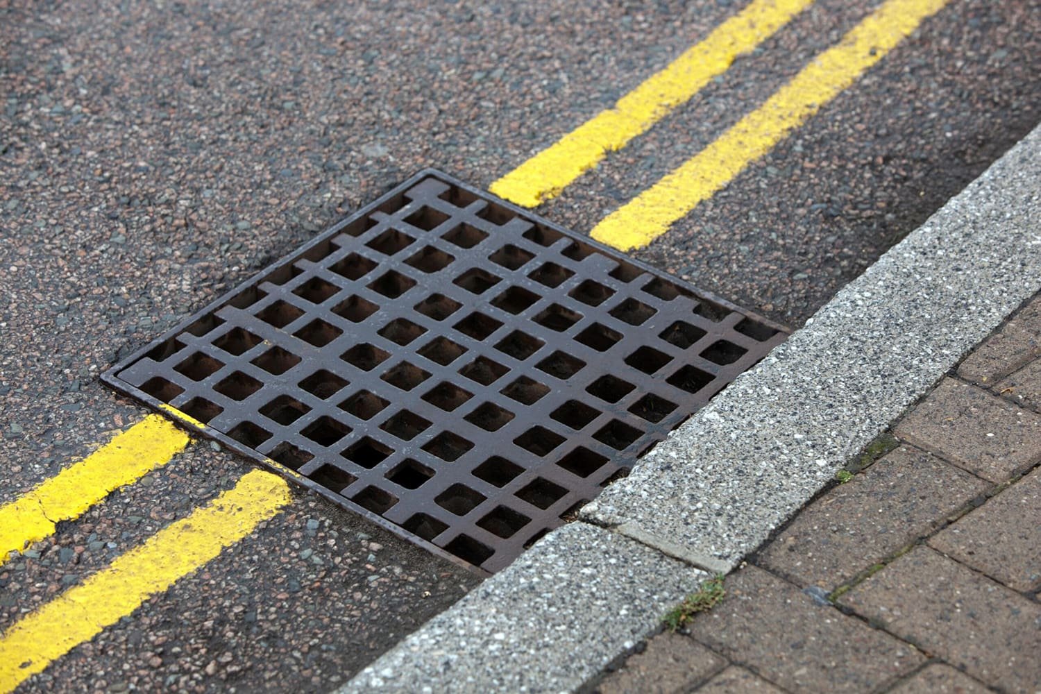 Kerbside stormwater grate and pit in a Gold Coast street