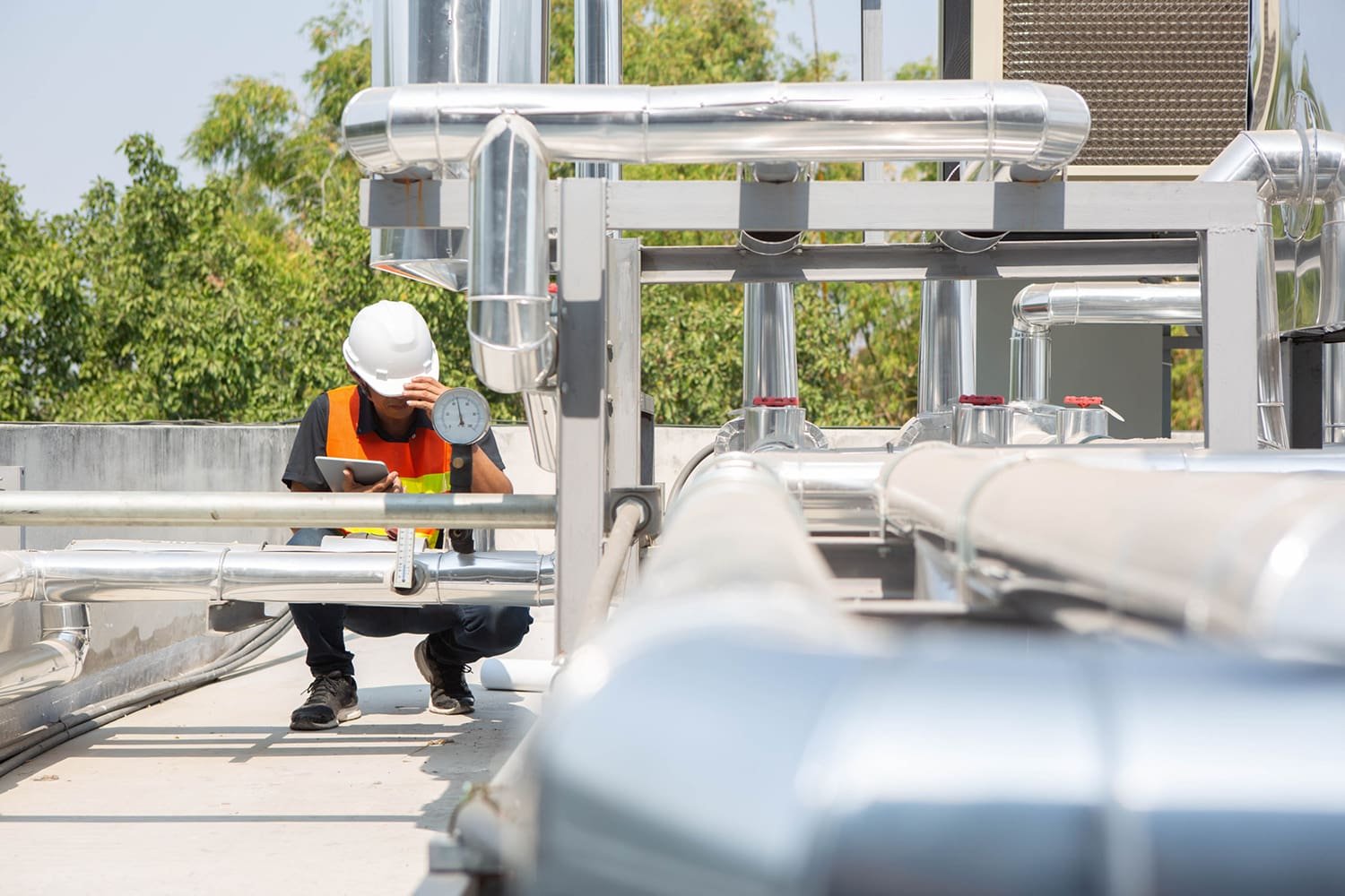 Plumber checking pressure gauges on an installed water supply system in Brisbane